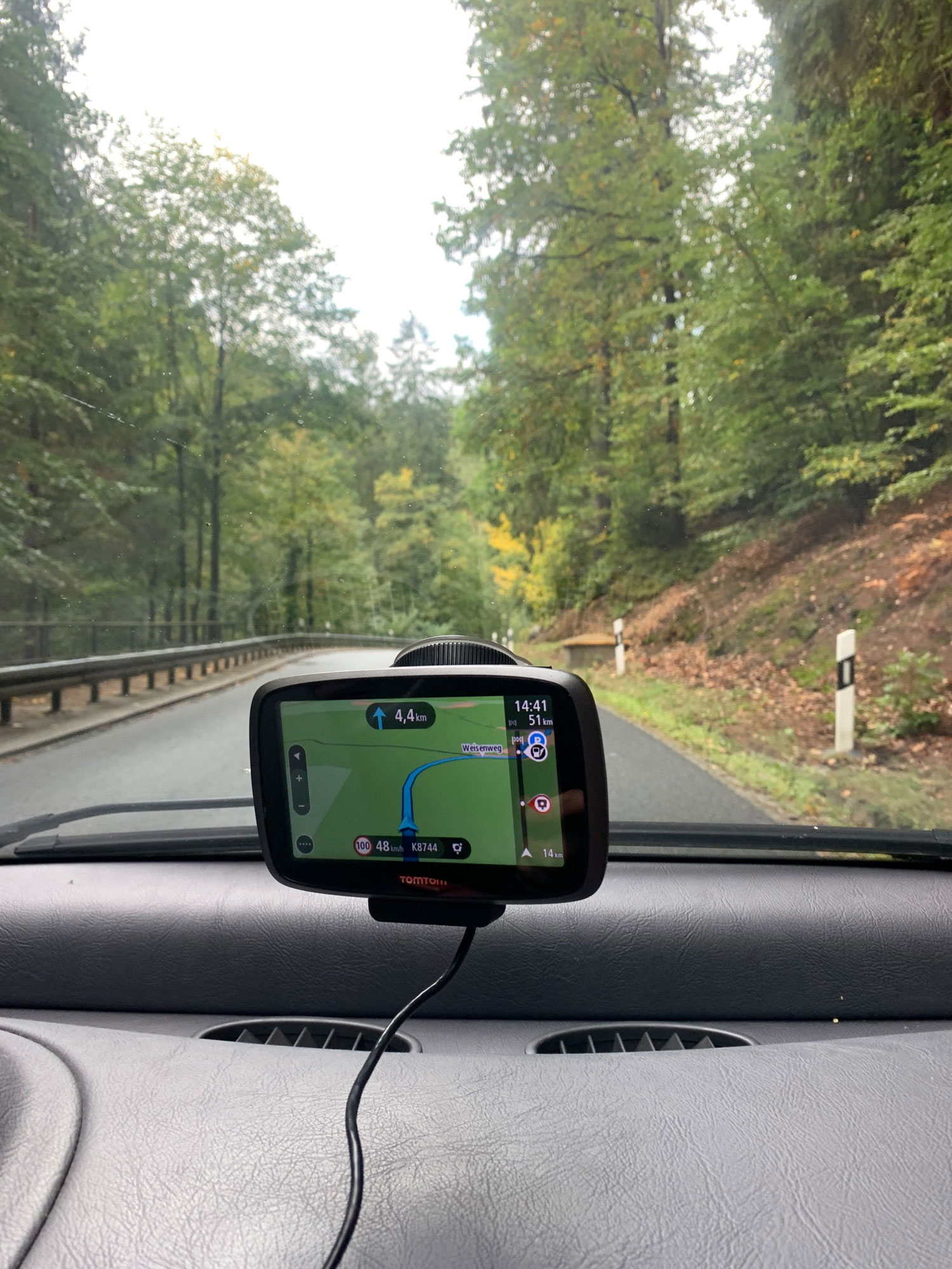 GPS and road curving ahead out the front window of a car in Saxon Switzerland